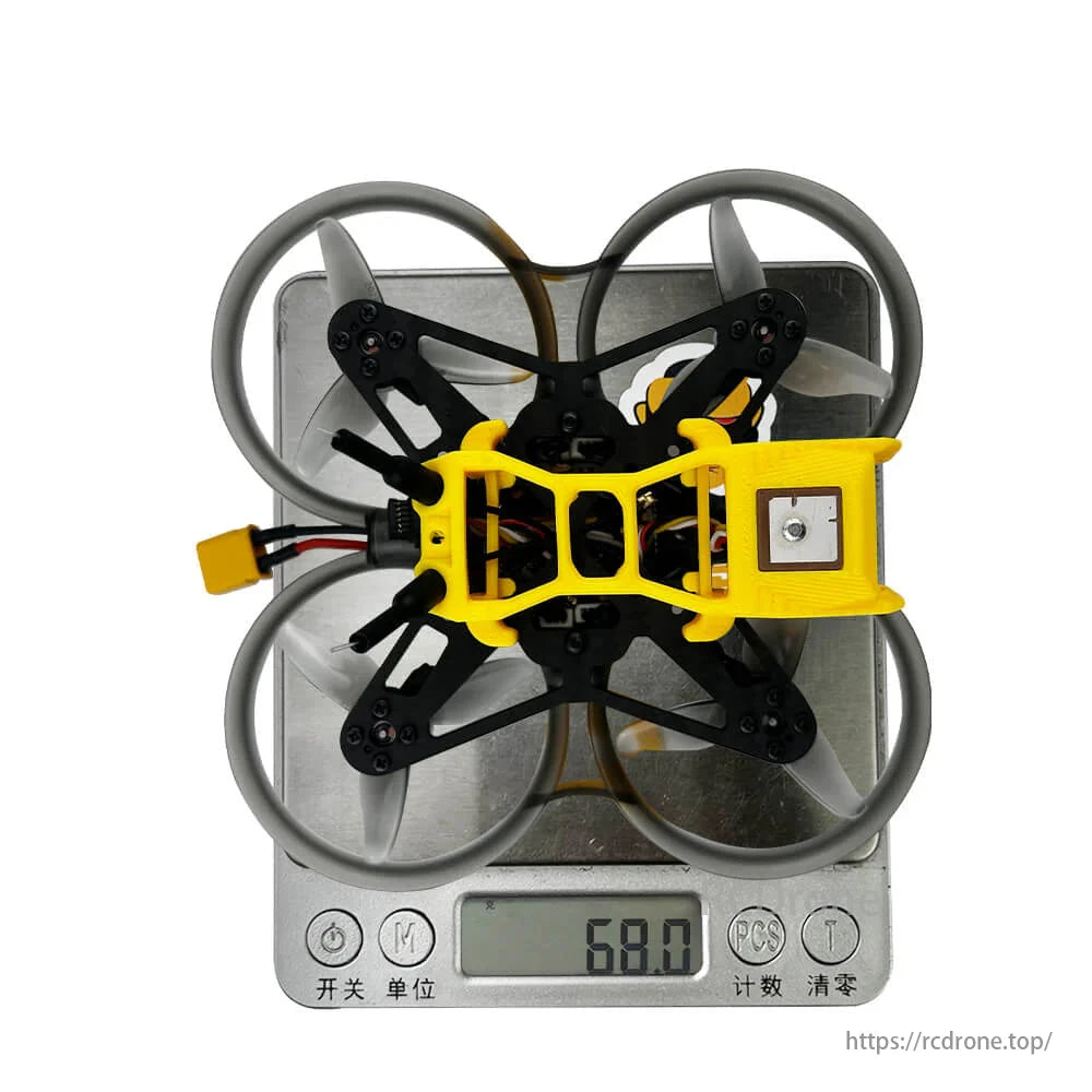 DarwinFPV CineApe20, a 2-inch 3S FPV drone with DJI O4/O4 Pro, GPS, and 1103 motor, showcased on a digital scale.