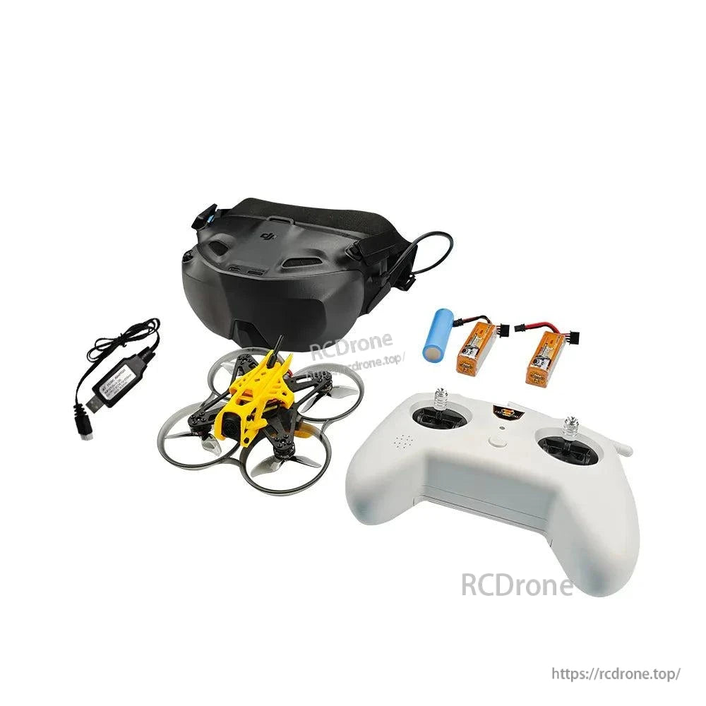 Angled view of FPV kit: black goggles, yellow ducted quadcopter, white controller, USB charger and batteries
