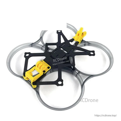 Angled view of ducted cinewhoop frame with carbon fiber plate stack and yellow TPU mounts