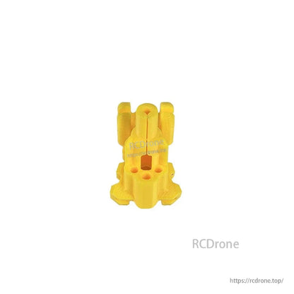 Yellow TPU mount piece, angled view showing mounting holes and side contours