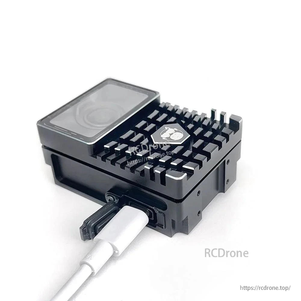 USB-C port close-up with cable plugged into the side of the case, showing finned top surface