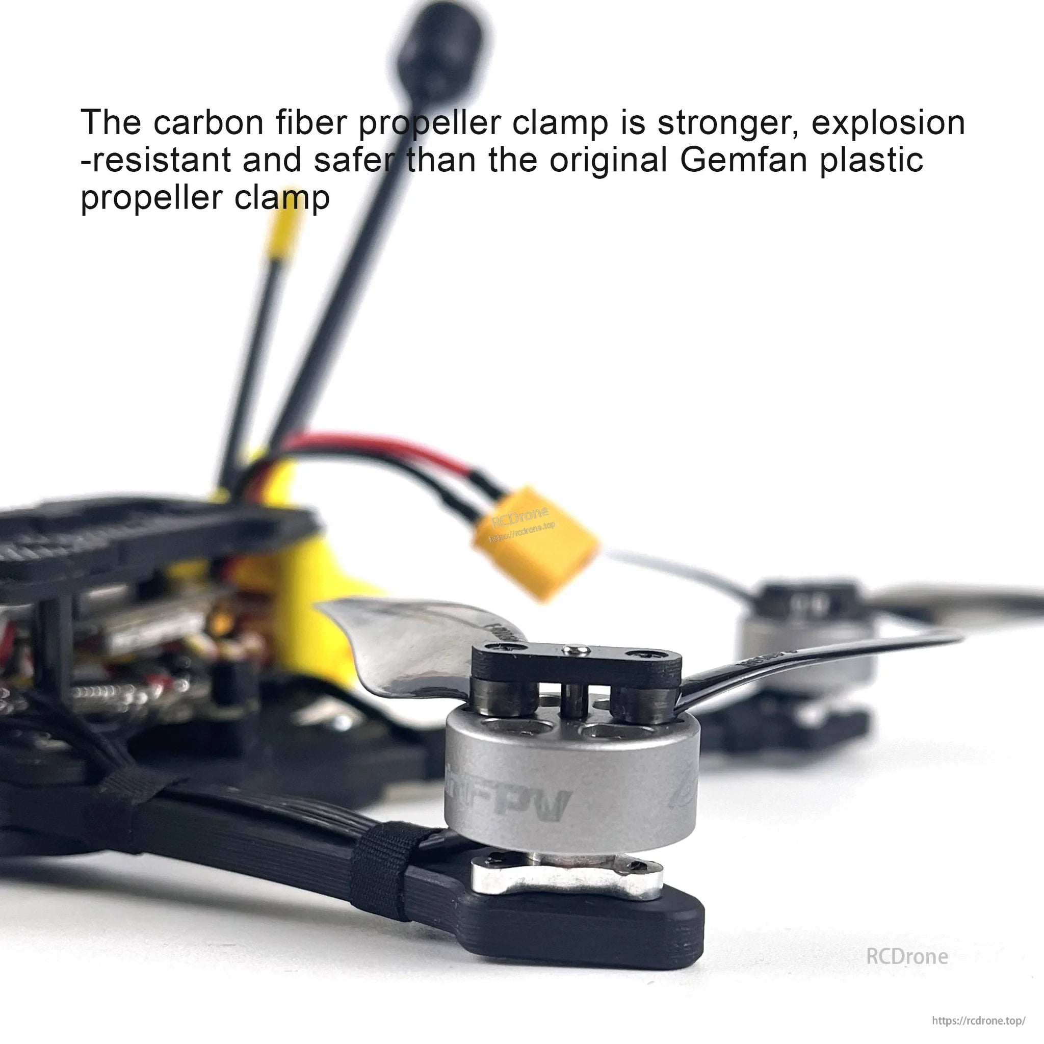 Close-up of carbon fiber propeller clamp installed on a motor, supporting the folding propeller blades