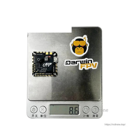 F435 AIO flight controller on digital scale showing 8.6g weight
