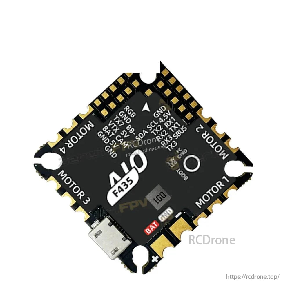 F435 AIO pad layout with labeled UART, SBUS, I2C, and RGB solder pads, angled view