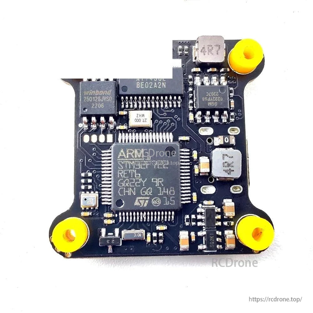 Flight controller chip-side view with components and corner mounting grommets