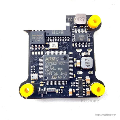 Flight controller chip-side view with components and corner mounting grommets