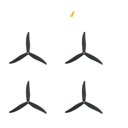 Set of four black tri-blade propellers arranged in a 2x2 layout, top view
