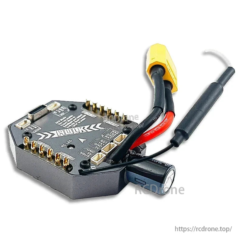 Angled view of HULK AIO flight controller board showing motor pads, capacitor, and XT60 power lead