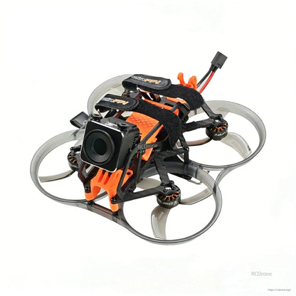 Angled front view with cube action camera mounted on orange bracket and ducted prop guards