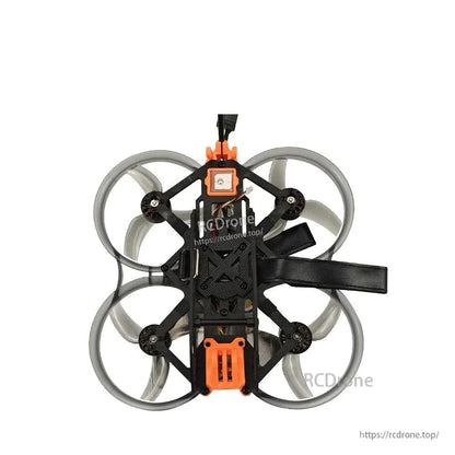 Bottom view of ducted quad with battery strap extended, showing frame layout and prop guards