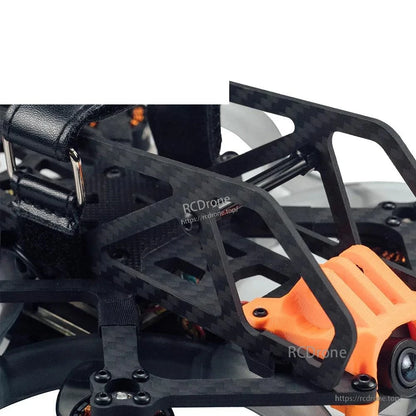 Carbon fiber side cage close-up with orange camera mount bracket and frame geometry details