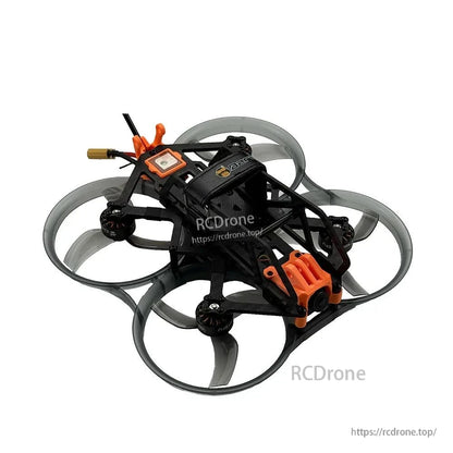 Three-quarter view showing carbon frame cage, orange camera mount, and rear wiring exit