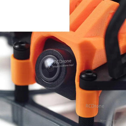 Close-up of front FPV camera lens mounted in orange protective housing