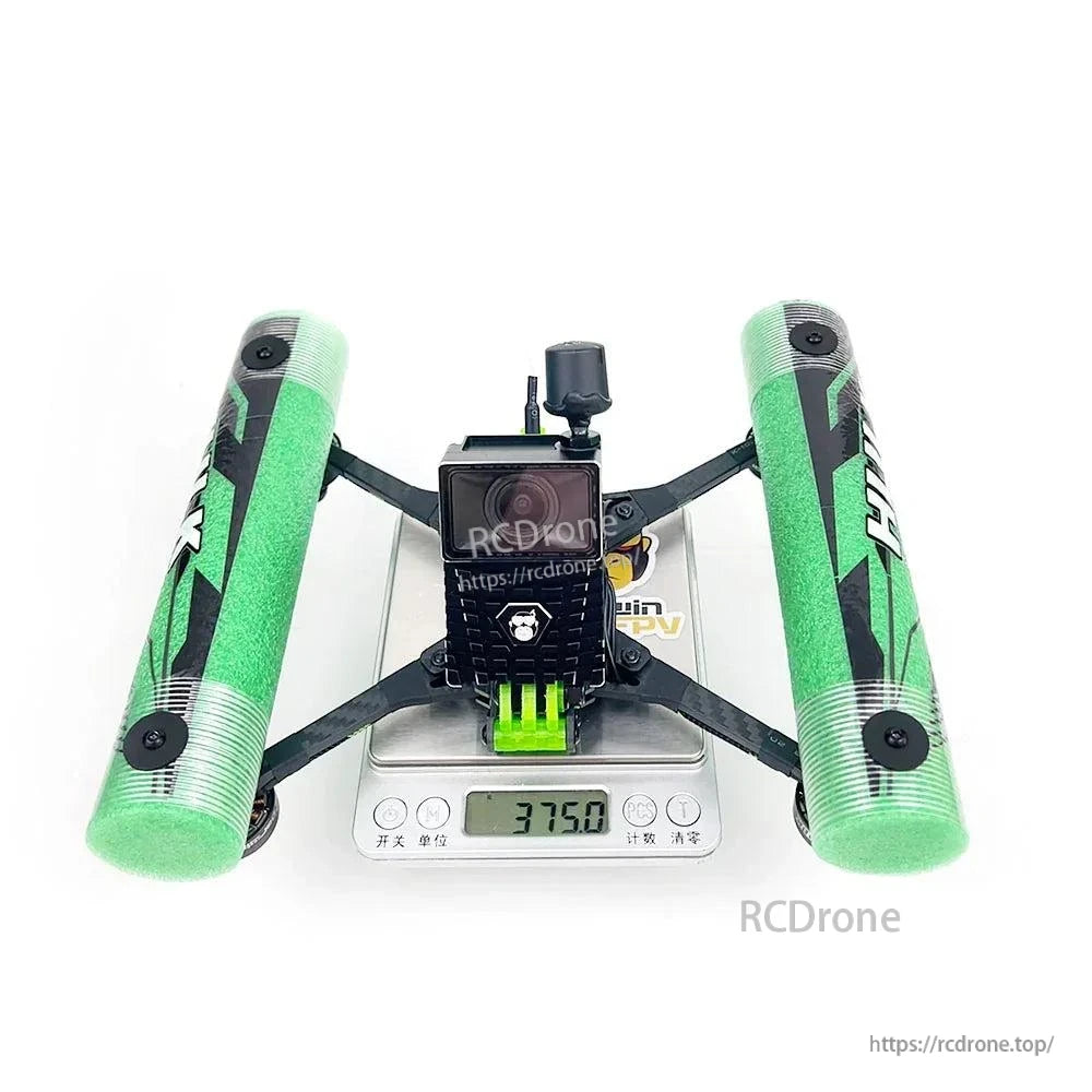 Rear/top view on digital scale showing camera mount and green foam side bumpers
