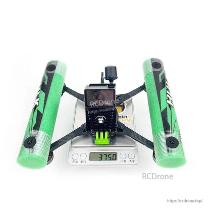 Rear/top view on digital scale showing camera mount and green foam side bumpers