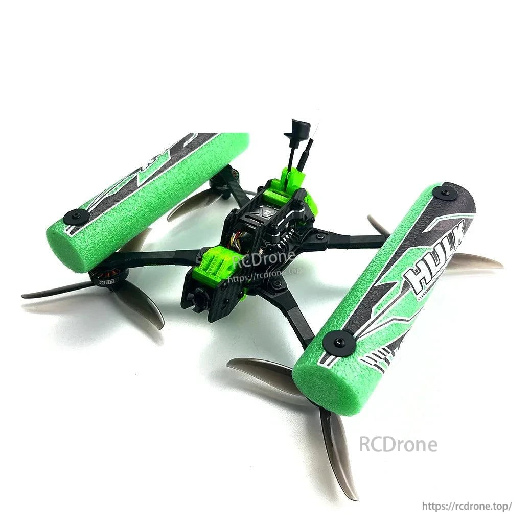 HULK FPV drone with green foam side bumpers, angled view highlighting squashed X frame and props