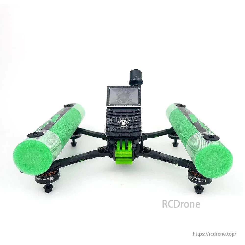 Front view of FPV drone showing camera housing, antenna mount, and green foam side bumpers