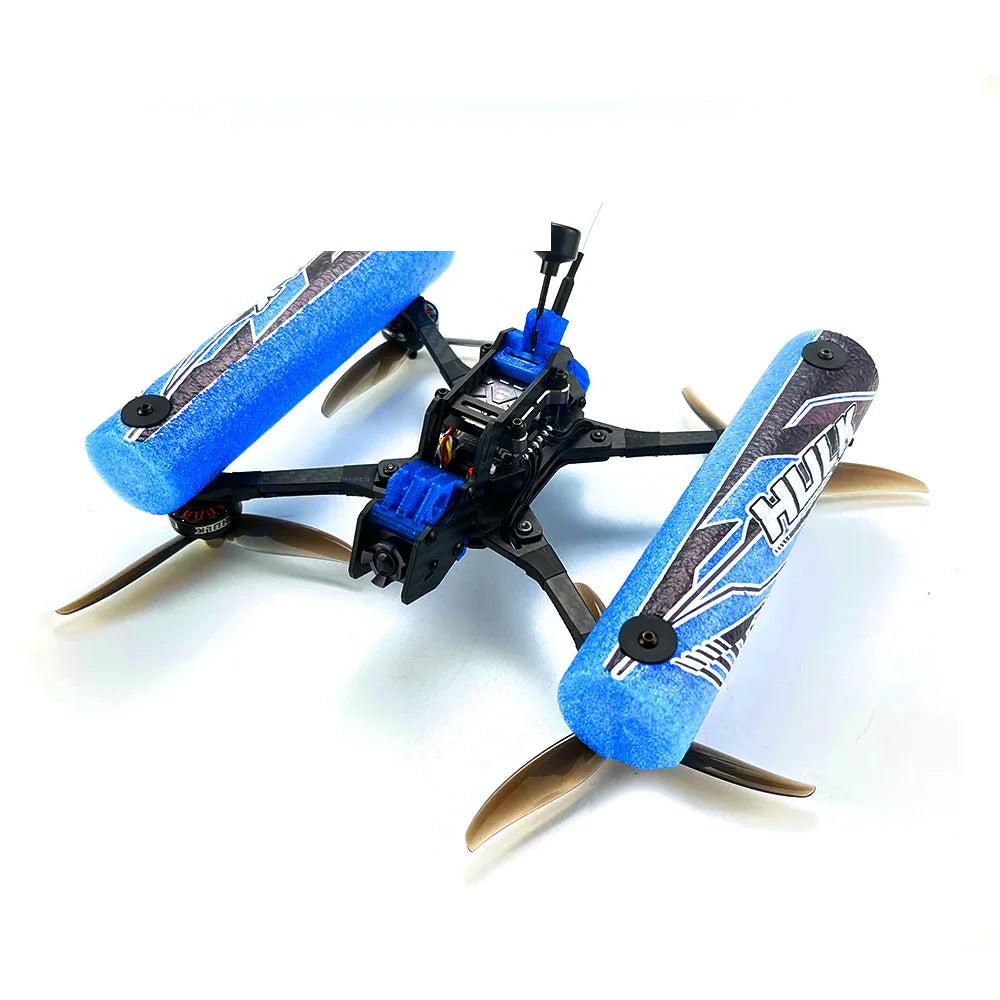 HULK FPV drone with blue foam side bumpers, angled side view emphasizing prop clearance and frame arms