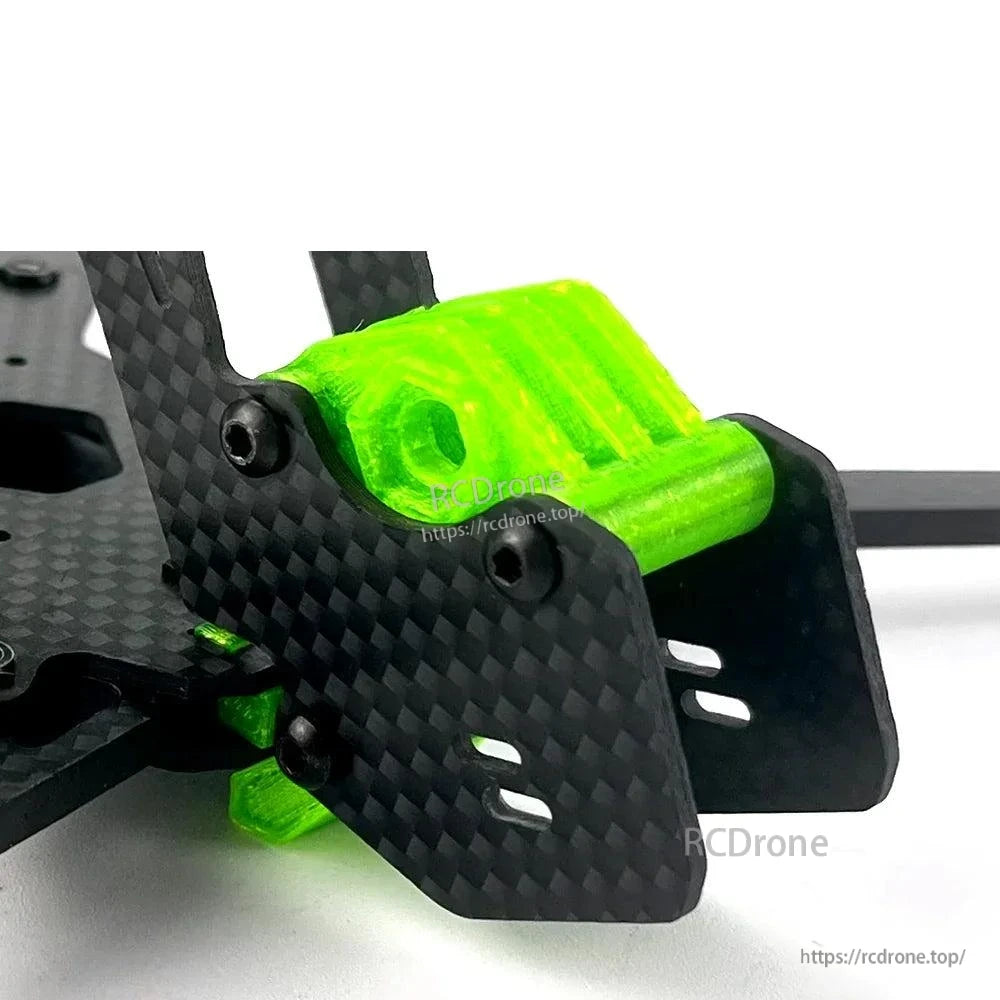 Close-up of front carbon fiber plates with green TPU bumper/mount and bolt hardware
