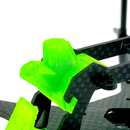 Close-up of green TPU quick-release top mount on carbon fiber side plates