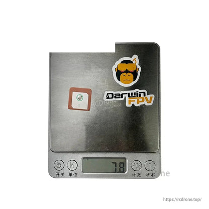 GPS antenna shown on digital scale displaying 7.8 g weight