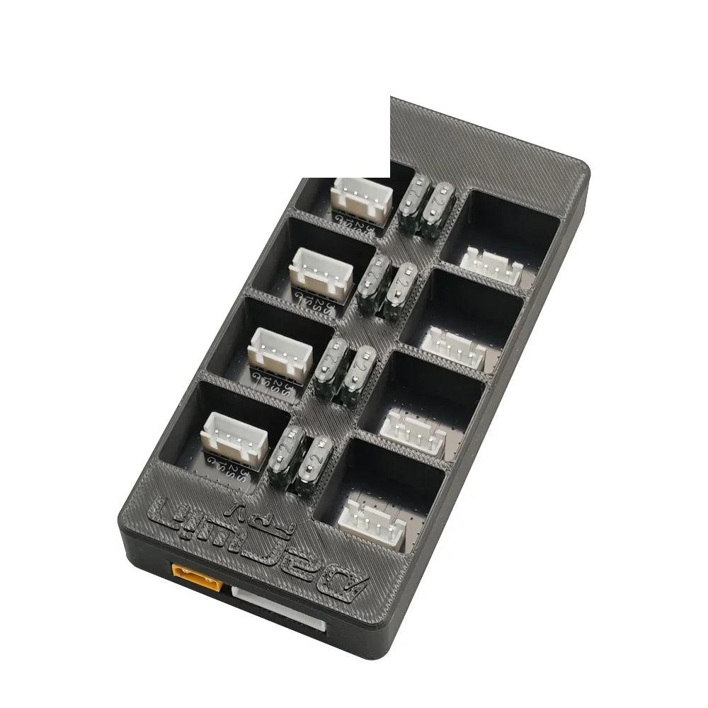 Top angled view of parallel charging board showing multiple white balance connectors and fuse positions