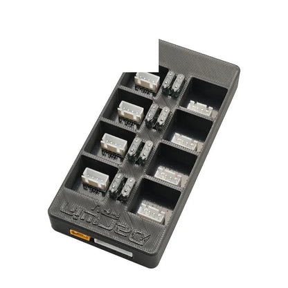 Top angled view of parallel charging board showing multiple white balance connectors and fuse positions