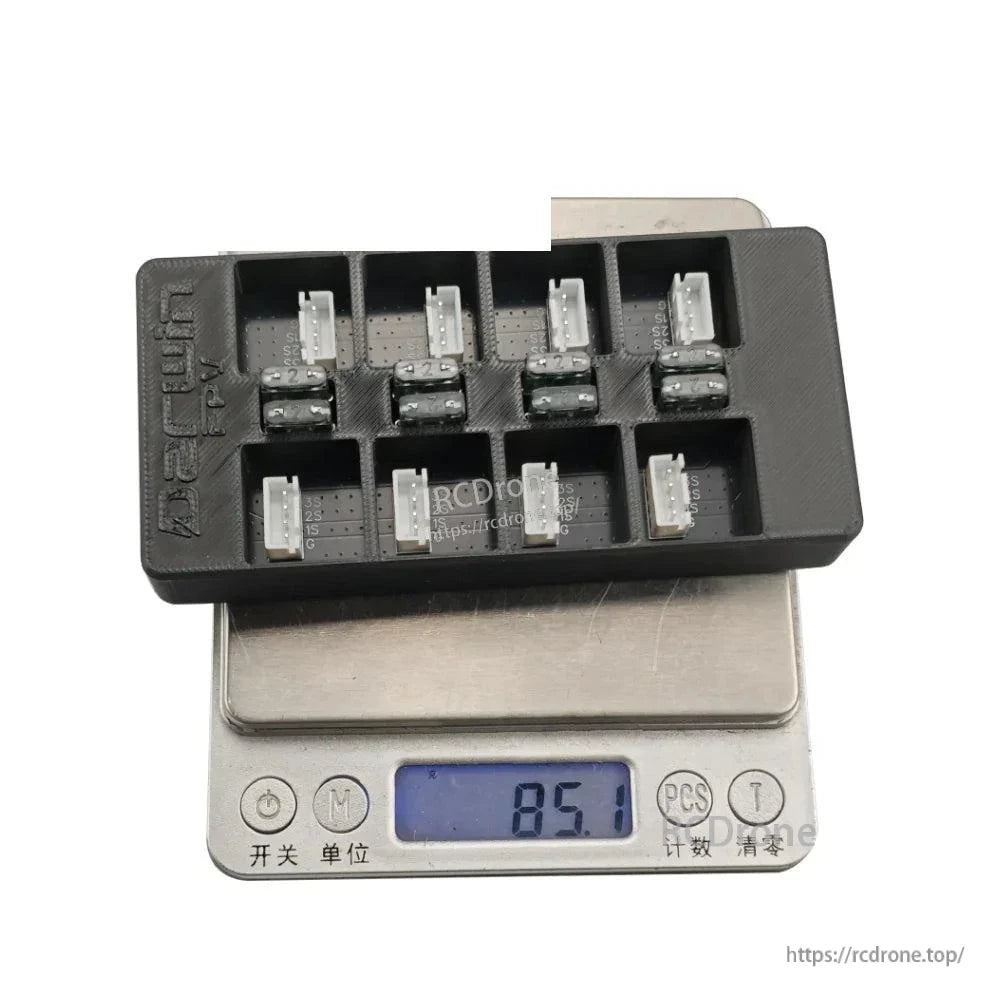 Parallel charging board on scale showing 85.1 g, displaying multiple balance connectors and fuse row