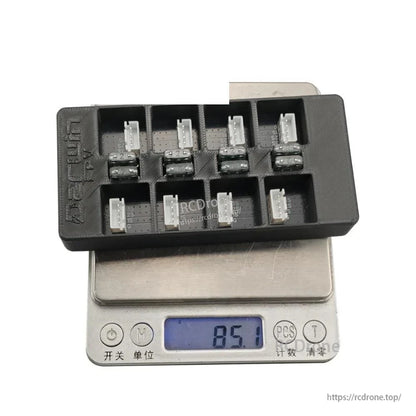 Parallel charging board on scale showing 85.1 g, displaying multiple balance connectors and fuse row