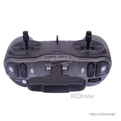 Top edge view of TX-Lite transmitter showing AUX switches, shoulder buttons, and antenna mount