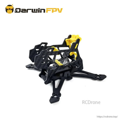 Assembled FPV frame with yellow TPU mounts installed on carbon body, front-left angle view