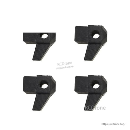 Four black arm clamp blocks with center bolt hole for tube arm mounting