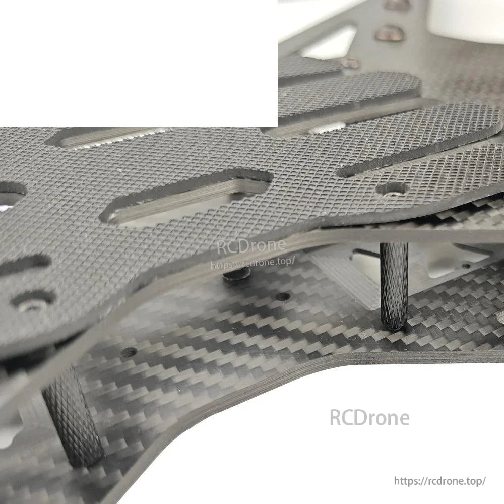 Close-up of carbon fiber frame standoffs and plate spacing on Toruk15 15-inch FPV drone frame