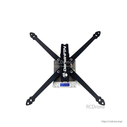 DarwinFPV X10 foldable 10 inch FPV drone frame on a digital scale showing frame weight