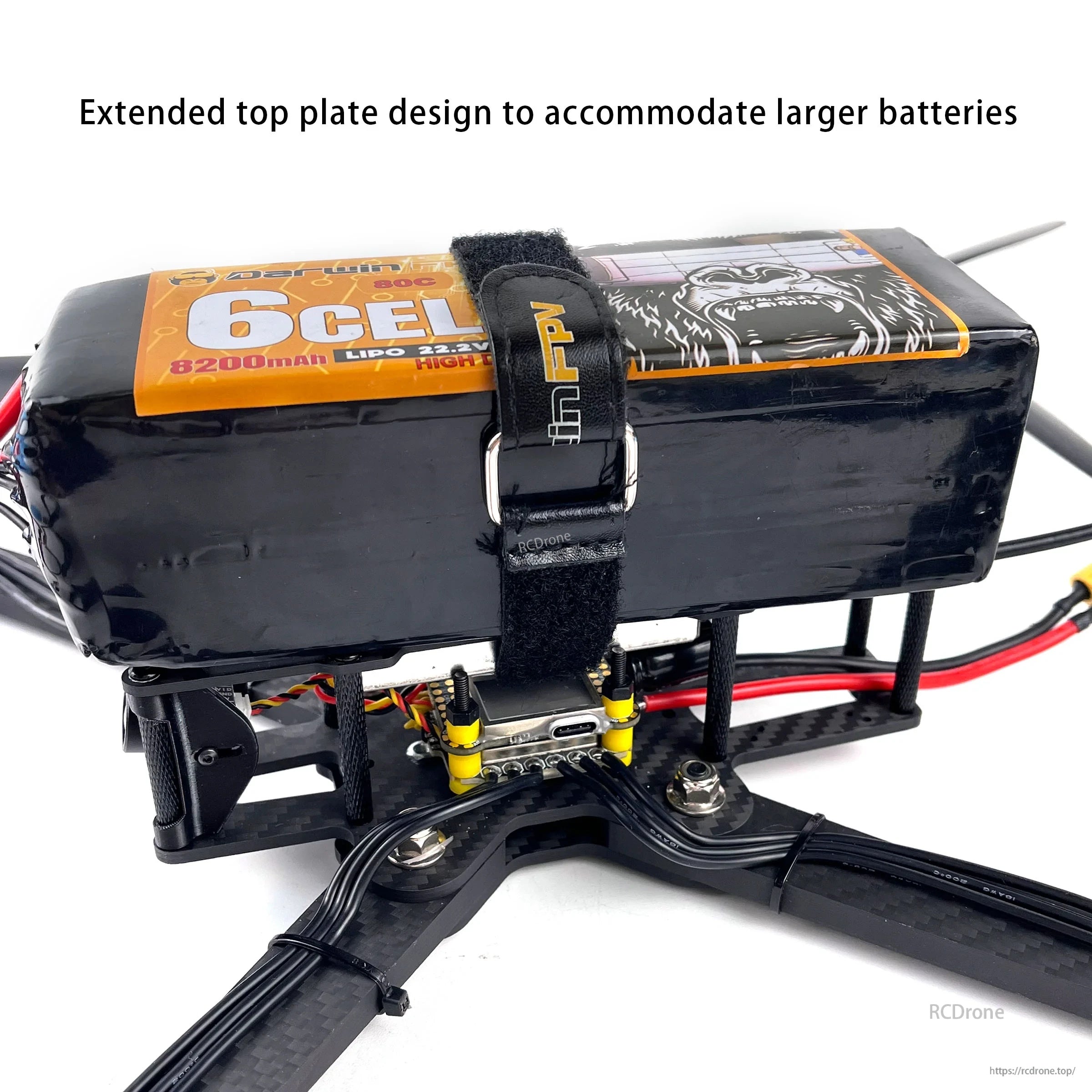 Extended top plate on DarwinFPV X10 frame supporting a large LiPo battery secured with strap and anti-slip pad