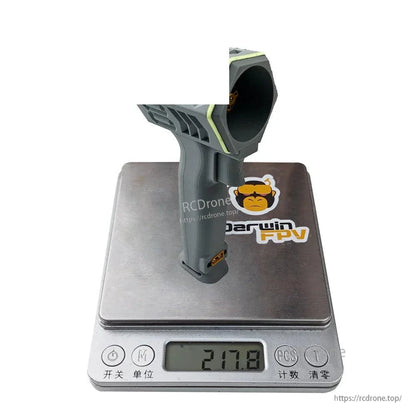 Gray handheld turbo fan shown on digital scale displaying 217.8 g weight