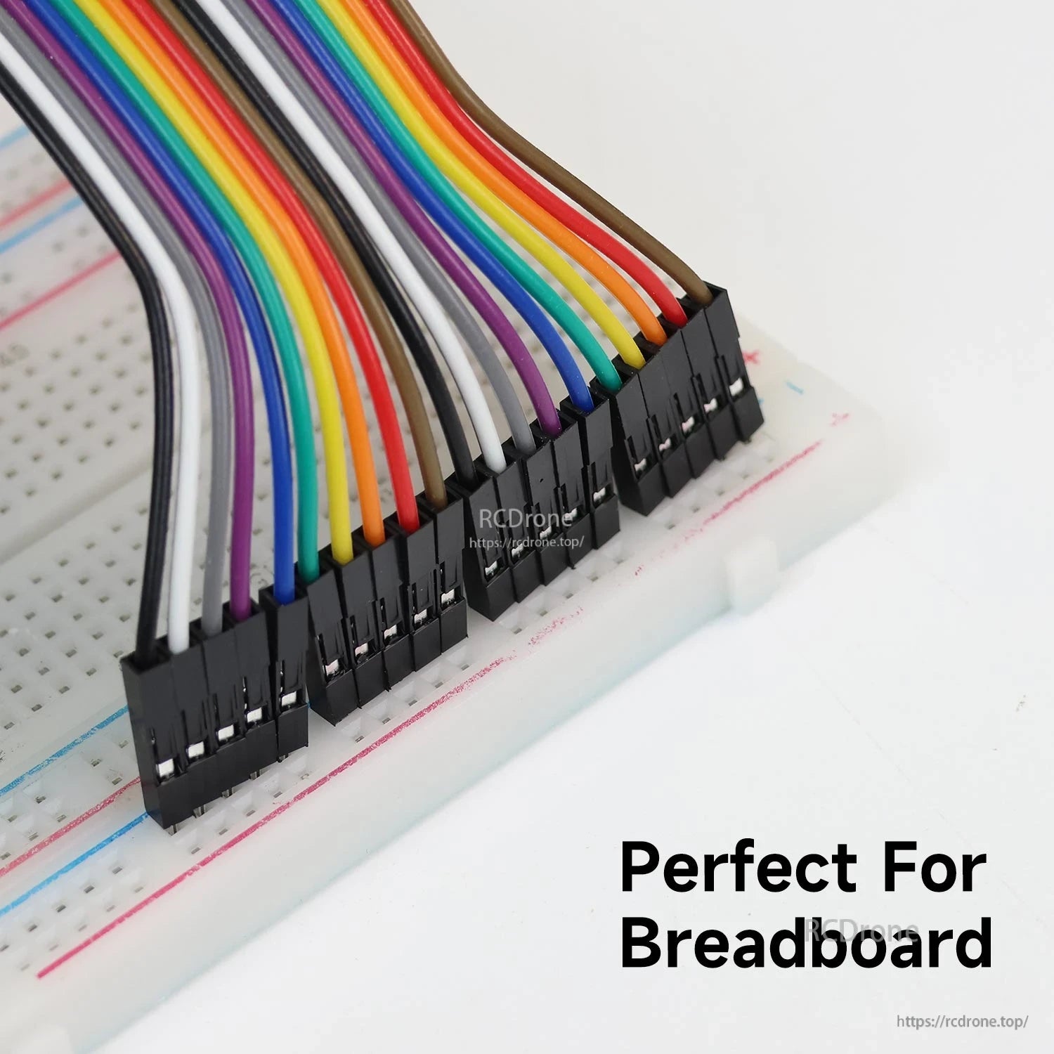 Dupont jumper wire connectors plugged into a breadboard, close-up showing pin alignment and fit
