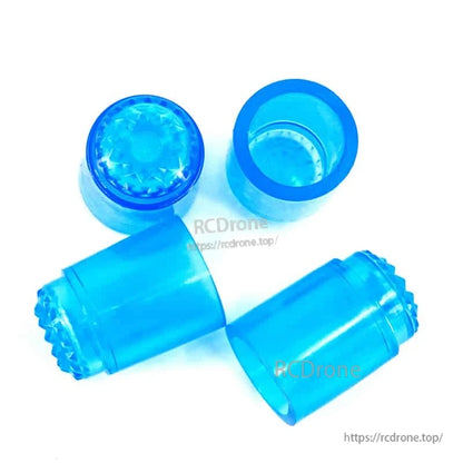 Blue translucent rubber stick caps set laid out on white background, showing open ends and textured tips