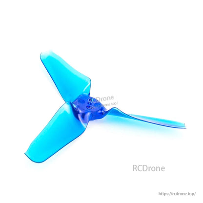 Single translucent blue tri-blade propeller close-up showing hub holes and blade shape