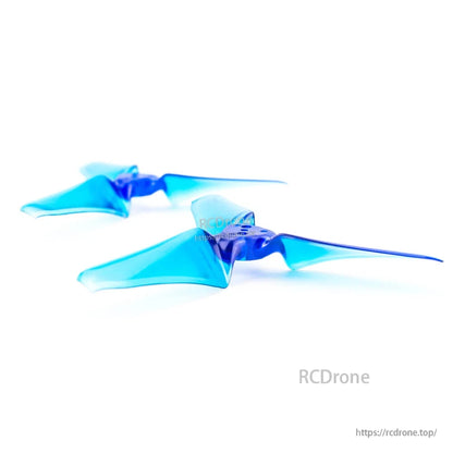 Two translucent blue tri-blade propellers close-up, angled view on white background