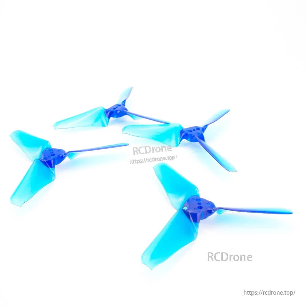Four translucent blue tri-blade propellers laid out on white background, assorted orientations