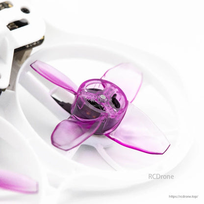 Close-up of a single purple 4-blade prop installed in a whoop duct, showing blade overlap