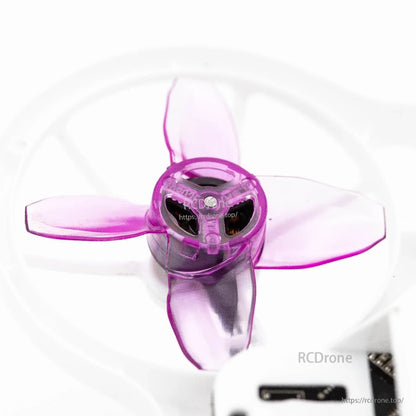 Top-down close-up of installed purple 4-blade prop showing hub openings and blade angles
