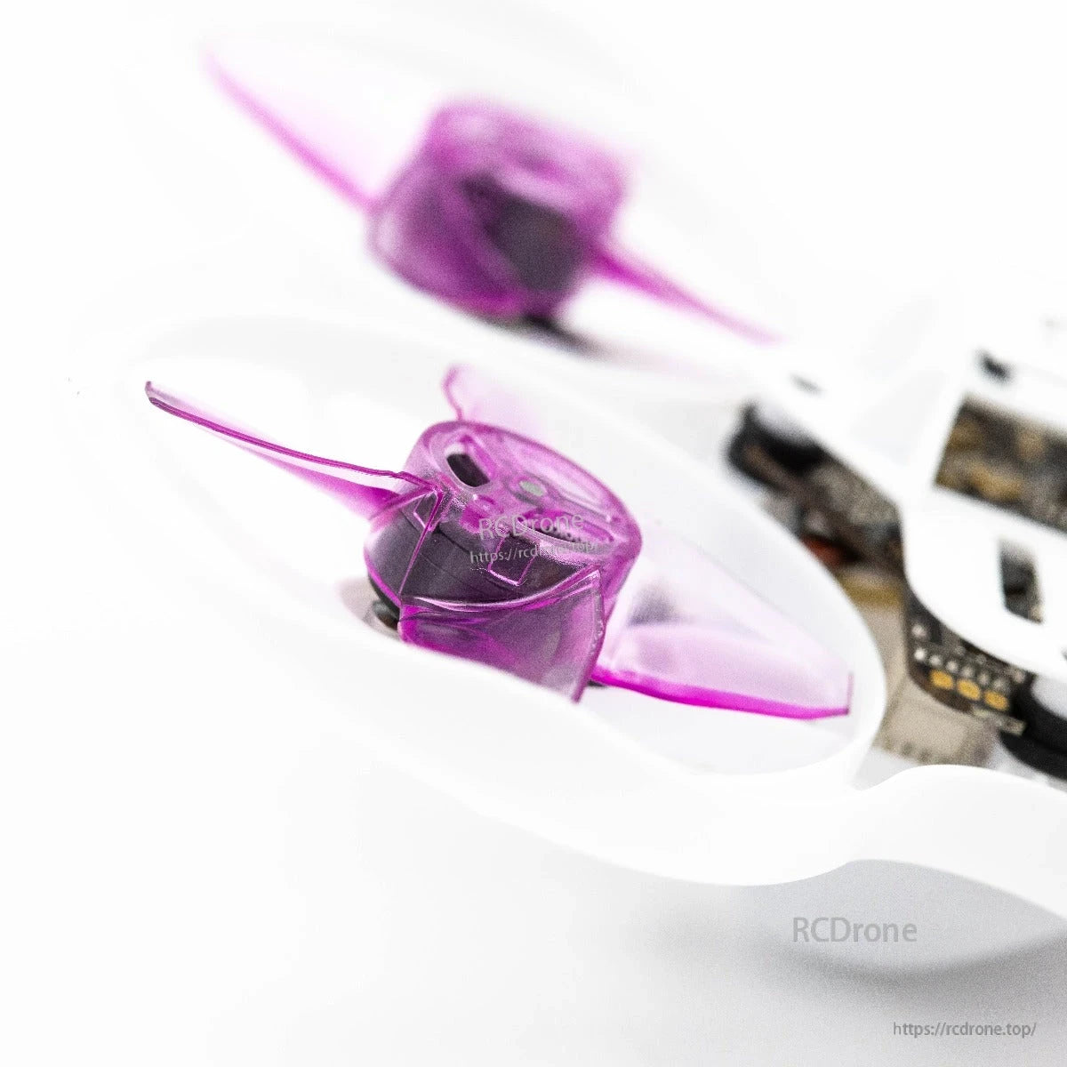 Side angle view of purple propeller mounted in whoop duct, showing blade depth and hub