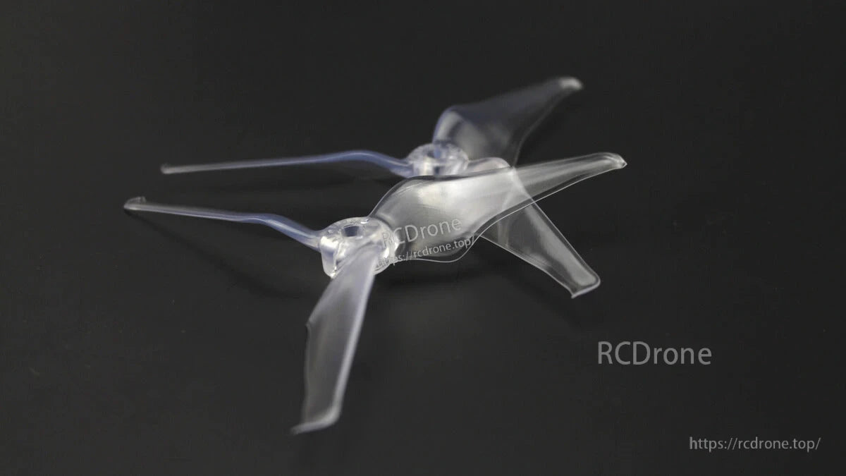 Clear EMAX Avan Flow 5x4.3x3 three-blade propeller shown at angle on dark surface