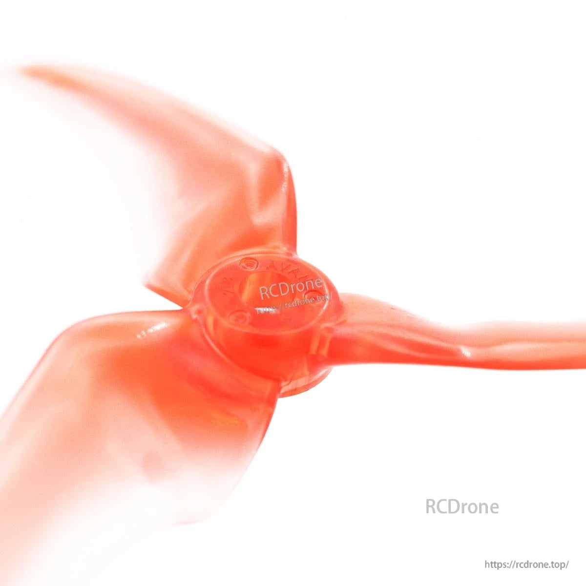 Center hub close-up on translucent red 3-blade propeller with mounting hole detail