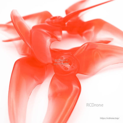 Close-up of EMAX Avan Scimitar 4028 propeller blades and hub detail, translucent red