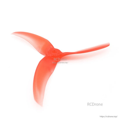 Single red tri-blade propeller angled view showing blade sweep and hub shape