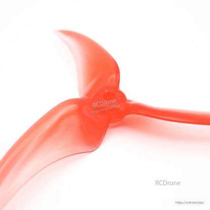 Close-up of blade root and hub transition area on translucent red tri-blade propeller
