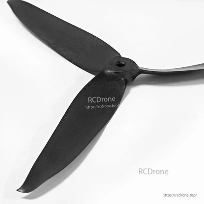 Close-up of propeller hub and mounting hole on black 3-blade FPV drone prop